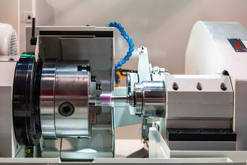 3 jaws chuck during holding clear plastic cylinder or workpiece set on high precision automatic cnc grinder machine for inside diameter or hole grinding of manufacturing finishing process