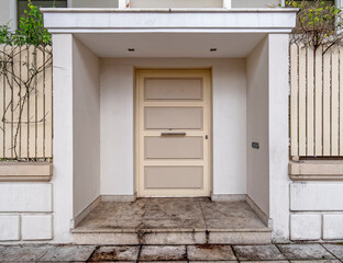 Fototapeta na wymiar contemporary house front entrance white door by the sidewalk