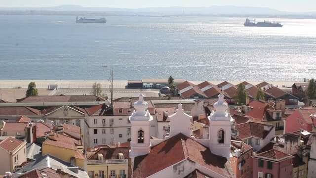 Lisbon city old town aerial view with Tages on the background. 