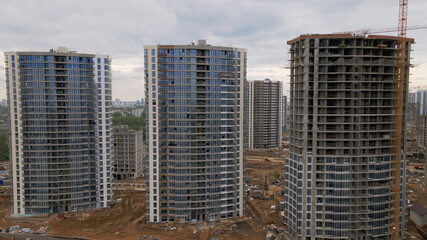 Modern urban development. Construction site with multi-storey buildings under construction. Construction work is underway. Aerial photography.