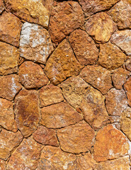 rough irregular cut brown stone wall, seamless pattern textured background