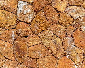 rough irregular cut brown stone wall, seamless pattern textured background