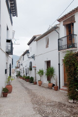 Empty street at Altea. Beautiful mediterranean town with white houses and clay pots along the street. Spain, Europe.