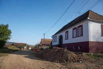 Fototapeta na wymiar unpaved streets and houses in the old village in Senereuș, Romania, 2020, September