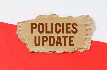 Against the background of the Polish flag lies cardboard with the inscription - Policies Update