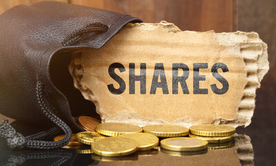 On the table is a bag of money from which sticks out cardboard with the inscription - SHARES