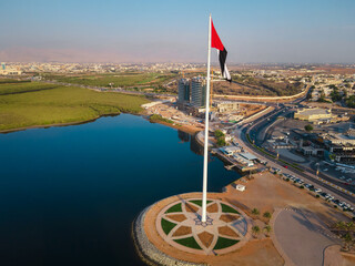 UAE flag and Ras al Khaimah emirate in the north United Arab Emirates aerial skyline landmark view