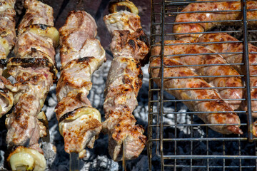 Grilled meat sausages on the grill. Process of cooking meat in grill. Barbecue. Close-up. Selective focus.