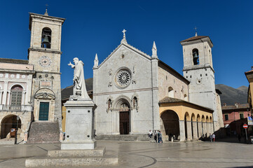 Fototapeta premium Italy Norcia 06.06.2015 Piazza san Benedetto with the statue of the saint and the basilica before the earthquake of 2016