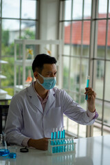 Asian medical  scientist working in clinical laboratory for virus vaccine 