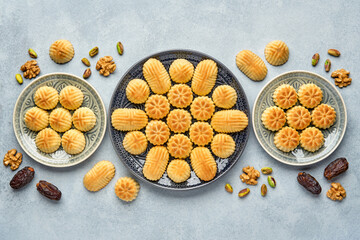 Arabic sweets. Traditional eid semolina maamoul or mamoul cookies with dates , walnuts and pistachio nuts . Top view