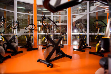 Fototapeta na wymiar Rows of stationary bike in gym modern fitness center.