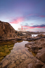 Amazing lighthouse in the Portuguese coastline at the sunset. Cascais Portugal