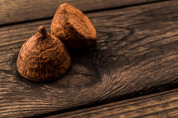 Chocolate truffles on an old wooden table. Close up view