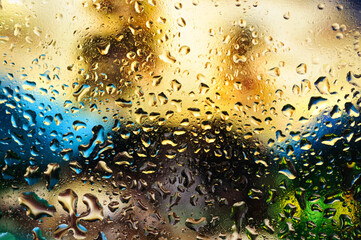 Abstract image of different natural colors with water drops on glass.