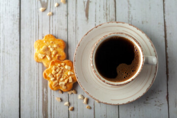 Cup of aromatic coffee on an old white wooden table.