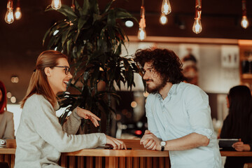 business couple sits in a cafe after a weekday