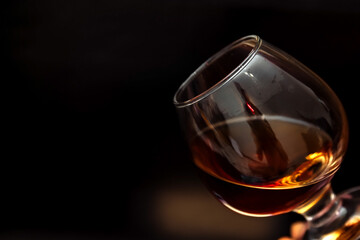 whiskey in a glass on a black background copy space. alcoholic drink scotch, cognac, brown. the concept of alcoholism