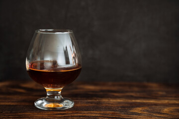 whiskey in a glass on a black background copy space. alcoholic drink scotch, cognac, brown. the concept of alcoholism