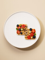 sandwiches with peanut butter with fruits and berries on a plate, top view. Healthy food concept