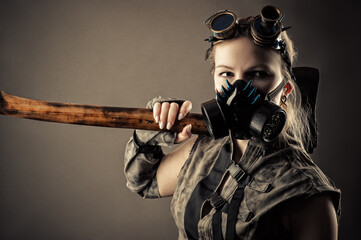 Fototapeta na wymiar brutal woman in a steampunk mask and ax in hands 