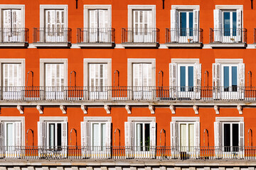 Obraz premium Red Plaster Facade of Old Building with Windows and Balconies in Plaza Mayor of Madrid