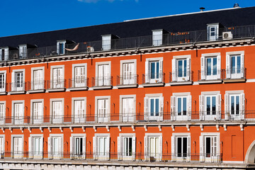 Red Plaster Facade of Old Building with Windows and Balconies in Plaza Mayor of Madrid