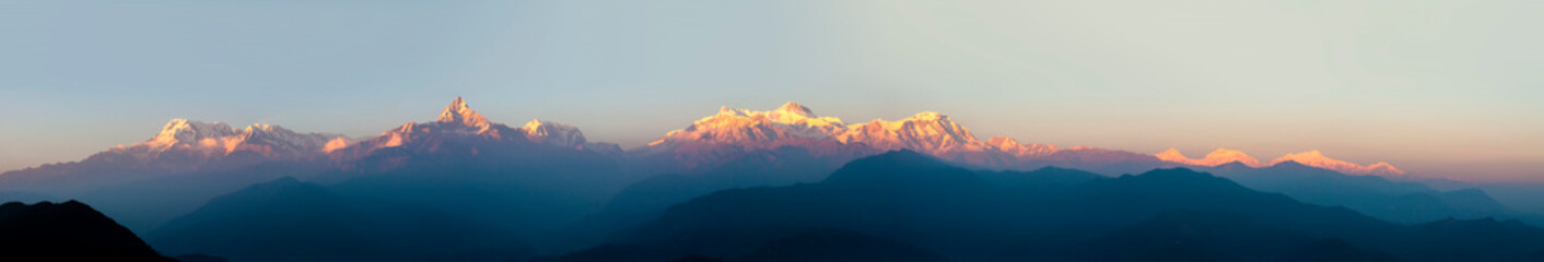 Panorama of Annapurna in Himalaya mountain range with sunset colors, Pokhara, Nepal