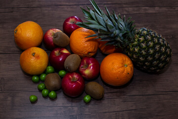 Naklejka na ściany i meble different fruits on wooden background close up