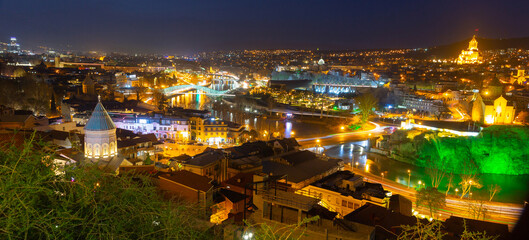 Scenic cityscape of town Tbilisi with illuminated buildings and bridges over Kura river, Georgia © JackF