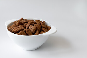bowl with chocolate corn pads isolated on white background, cereals breakfast