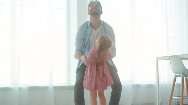 Happy father hugging little daughter in home interior. Father's Day