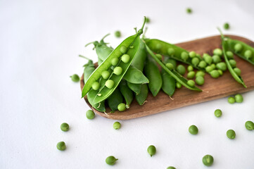 fresh peas with their pods, nutritious green