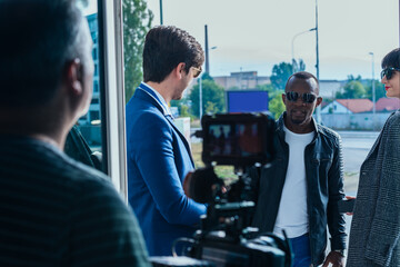 Videographer making video of young multi-ethnic business people