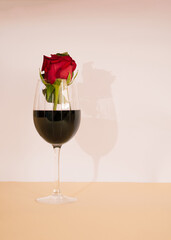 glass of red wine with rose in it.minimal art close up concept