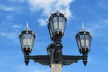 Fototapeta na wymiar Vintage street lamp on blue sky background