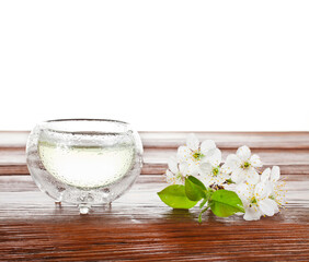 Green tea in a thermo cup with cherry flowers isolated on a white background.