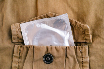 Condom in pocket of a beige jacket