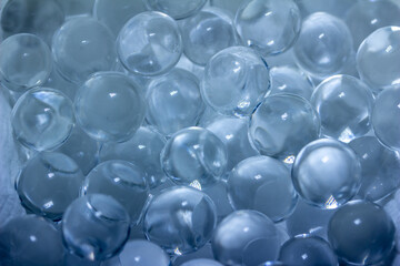Macro abstract texture background of super absorbent polymer water gel beads with the texture of soft clear wet marbles