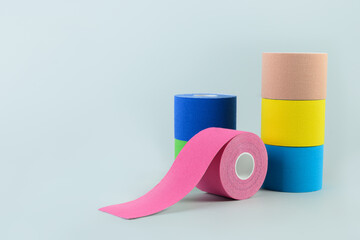 Rolls kinesiology tape for athletes on blue. Body correction and acceleration of lymph outflow....