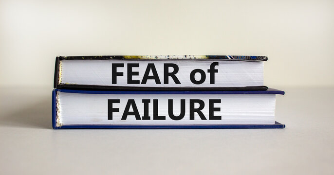Fear of failure symbol. Books with words 'fear of failure'. Beautiful white background, copy space. Business, fear of failure concept.