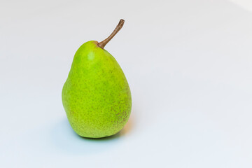 Green-yellow raw pear on white background