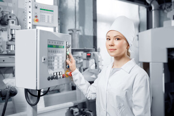 Woman operating work on food conveyor switchboard engineer machine control panel in mill flour, milk production plant - obrazy, fototapety, plakaty
