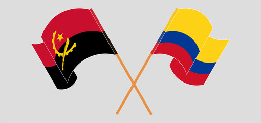 Crossed and waving flags of Angola and Colombia