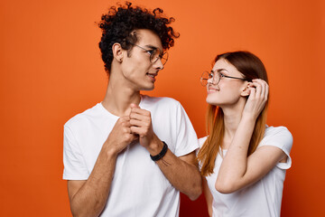 cheerful young couple wearing glasses communication isolated background