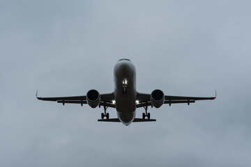 The silhouette of landing plane in front view