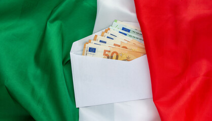 euro banknotes in an envelope against  Italian flag background, corruption, salary or savings...