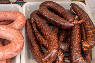 Typical Spanish sausages lying on a village stall at the food market