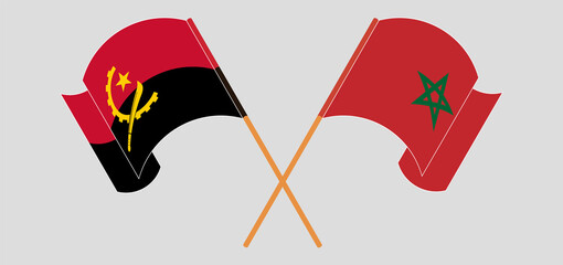 Crossed and waving flags of Angola and Morocco
