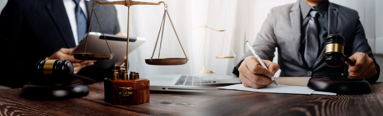 justice and law concept.Male judge in a courtroom on wooden table and Counselor or Male lawyer...